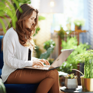 Smiling woman typing in a bright room